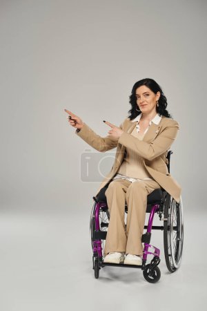 good looking woman with ability disability sitting in wheelchair and gesturing, looking at camera