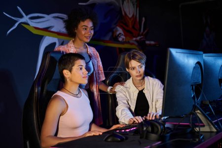 Diverse group of women focused on a cybersport gaming session, interracial players concept
