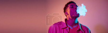 Photo for Portrait of african american man exhaling smoke against vibrant background with lighting, banner - Royalty Free Image