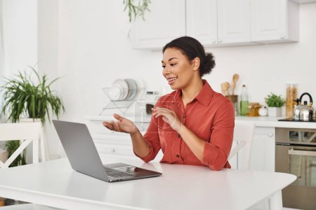 happy african american nutritionist providing online consultation while working remotely from home