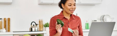 african american nutritionist holding avocado and supplements while giving diet advice, banner