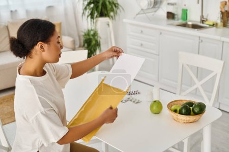 brunette african american woman reviewing dietary plan near supplements on kitchen table