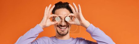 Photo for Happy man holding bitcoins near eyes and smiling on orange background, cryptocurrency banner - Royalty Free Image