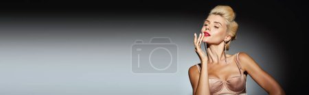 banner of beauty girl with blonde hair touching her lips with hand against grey background