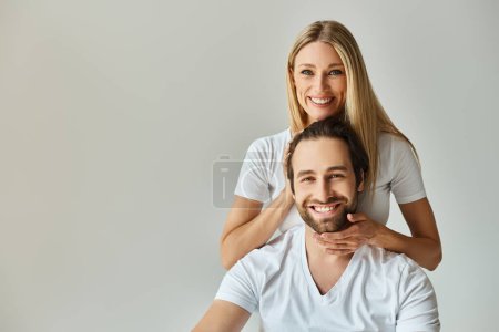 couple engage in a romantic embrace as the woman touching head of her man, symbolizing unity and passion.