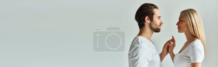 Photo for A man and a woman stand face to face, enveloped in a moment of intimacy and romance, banner - Royalty Free Image