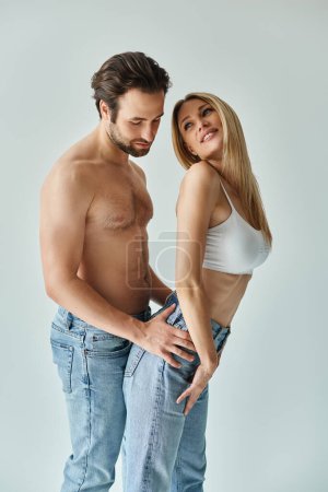 Photo for A sexy couple, expressing romance and closeness as they stand side by side. - Royalty Free Image