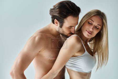 Photo for A sensual moment captured between a man and a woman as they embrace each other in a romantic display of affection. - Royalty Free Image