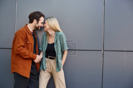 Photo for A handsome man and a beautiful woman stand intimately close, exuding passion and romance in every glance and touch. - Royalty Free Image