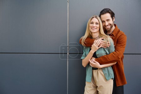 Photo for A sensual couple, deeply in love, share a passionate embrace against a textured wall. - Royalty Free Image