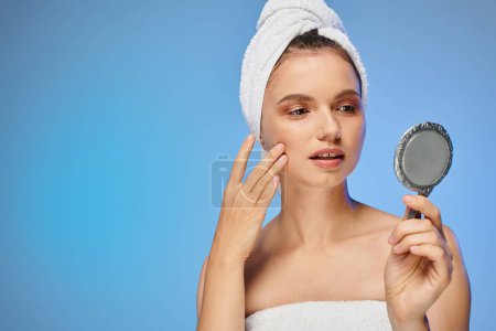 Photo for Attractive woman with towel on head touching perfect skin on face on yellow backdrop, beauty - Royalty Free Image
