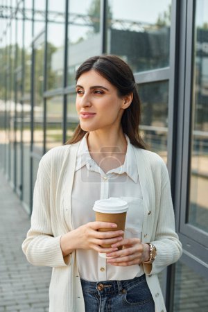 A businesswoman relishes a cup of coffee in a modern outdoor office setting, embodying the franchise concept.