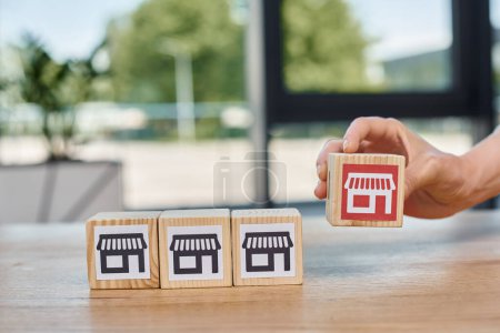 Photo for A businesswoman joyfully arranges wooden blocks engraved with symbols, exploring the art and culture they represent. - Royalty Free Image