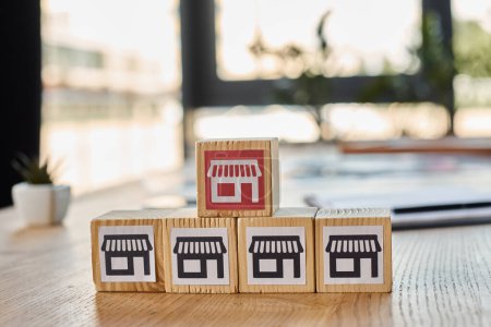 Ein Holzblock mit einem Miniaturladen an der Spitze, der ein kreatives Franchise-Konzept in einem modernen Büroambiente darstellt.