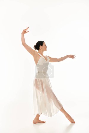 A graceful young woman in a flowing white dress expresses the beauty of movement through dance.