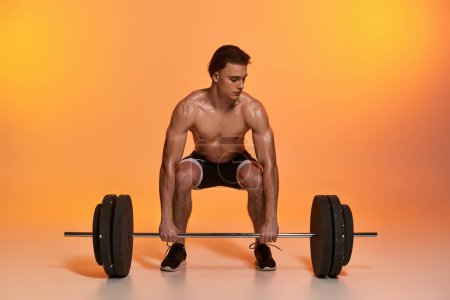 Photo for Alluring shirtless muscular man in black pants exercising with barbell on vibrant orange backdrop - Royalty Free Image