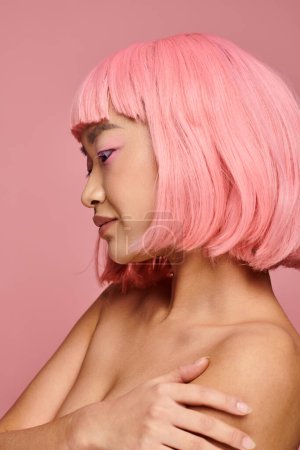 profile of alluring asian young woman with pink hair and makeup against vibrant background