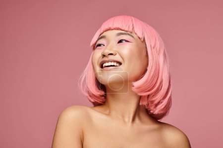 portrait of charming asian girl with nose piercing laughing looking to up against vibrant background