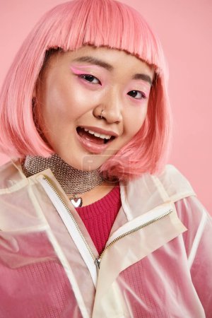 portrait of cute asian young woman with silver necklace, pink hair and makeup on vibrant background