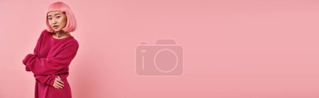 Photo for Horizontal shot of alluring asian woman in her 20s posing with hands against pink background - Royalty Free Image