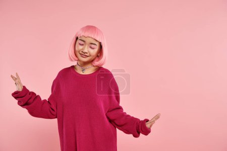Photo for Cute and pretty asian girl in vibrant sweater outfit closing eyes and spread arm to side - Royalty Free Image