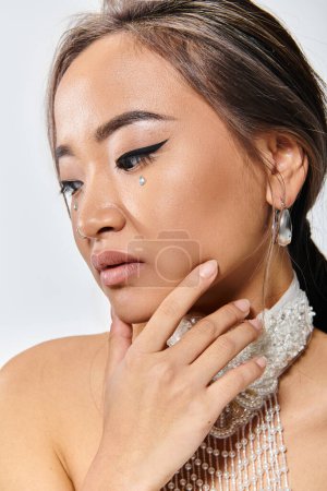 close up with profile attractive woman with grace makeup and necklace delicate posing with hand