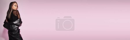 Photo for Horizontal shot of attractive asian woman in 20s with daring makeup looking to side from behind back - Royalty Free Image