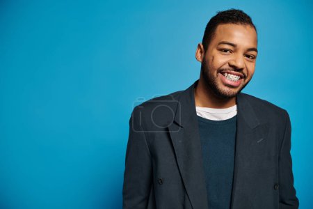 handsome african american young guy in dark blue outfit smiling to camera on vibrant background puzzle 698639722