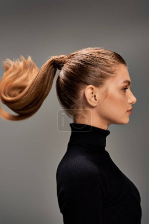 A young woman with long hair styled in a ponytail, exuding grace and serenity.