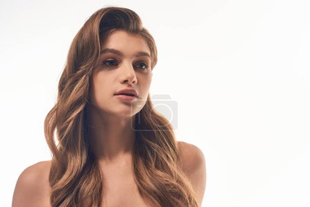 Photo for Attractive woman with long wavy hair, exuding elegance and grace. - Royalty Free Image