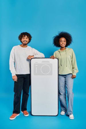 Photo for A couple of people from different cultural backgrounds stand side by side, showcasing unity and diversity. - Royalty Free Image