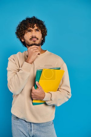 An Indian student with curly hair confidently holds a folder, exuding intelligence and diligence in a studio setting.