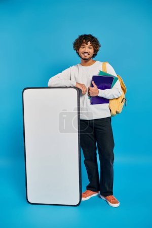 Photo for A man of diverse cultural background, holding a book and a suitcase, ready for a journey of knowledge and discovery. - Royalty Free Image