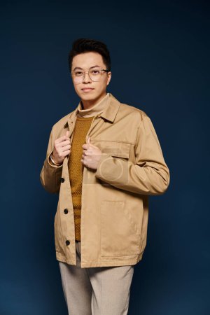 Young man in fashionable tan jacket and tie strikes a confident pose with active gestures.