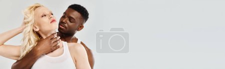 Photo for A young man holds a womans neck with both hands, their eyes locked in a passionate embrace. - Royalty Free Image