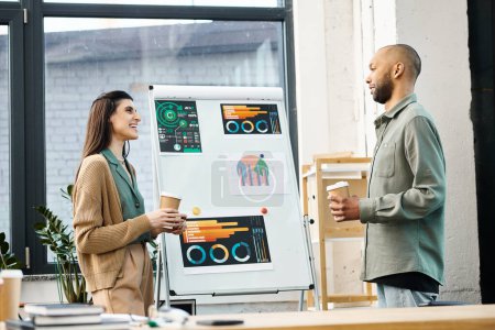 Photo for A man and a woman engaging in a corporate discussion, brainstorming ideas together in front of a whiteboard. - Royalty Free Image