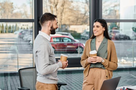 Photo for A man and a woman engage in a discussion at an office, reflecting a scene of corporate collaboration and teamwork. - Royalty Free Image