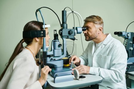 Appealing doctor checking his female patient vision.