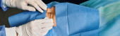A person in white gloves meticulously performs surgery. puzzle #701184880