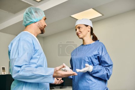 A man and a woman in scrubs having a discussion in a medical setting.