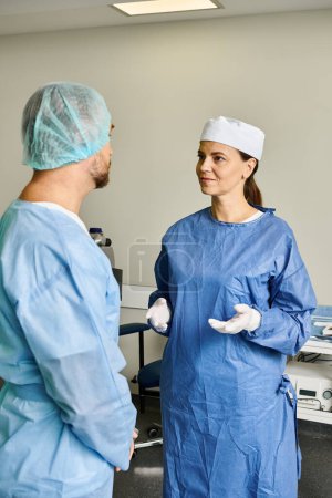 Photo for A man and woman in scrubs discussing laser vision correction. - Royalty Free Image
