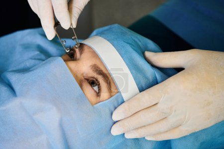 Devoted doctor performing laser vision correction on womans face.