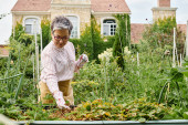 good looking happy mature woman with glasses working in her vivid green garden and smiling joyfully puzzle #701800112
