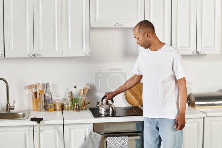 A disabled African American man with myasthenia gravis syndrome stands in a kitchen near stove