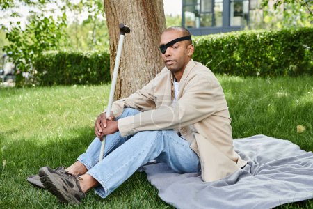 An African American man with myasthenia gravis syndrome relaxing on a blanket