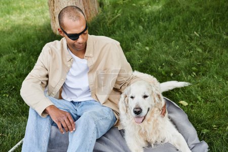 Ein behinderter Afroamerikaner mit Myasthenia gravis sitzt mit seinem treuen Labrador-Hund auf einer Decke und verkörpert Vielfalt und Inklusion.