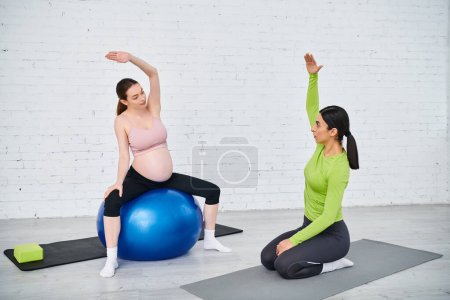 pregnant woman follow her coach, exercising yoga poses on exercise balls during parents courses.