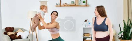 Photo for A young beautiful mother tenderly holding her baby in her arms at home, guided by her coach from parents courses. - Royalty Free Image