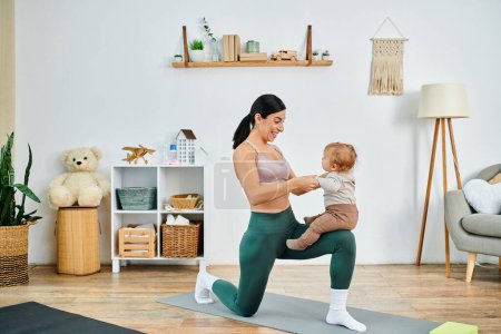 A young, beautiful mother gracefully practices yoga with her baby, guided by a coach in a nurturing home environment.