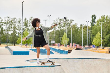 A young African American woman with curly hair skillfully riding a skateboard at a bustling skate park.